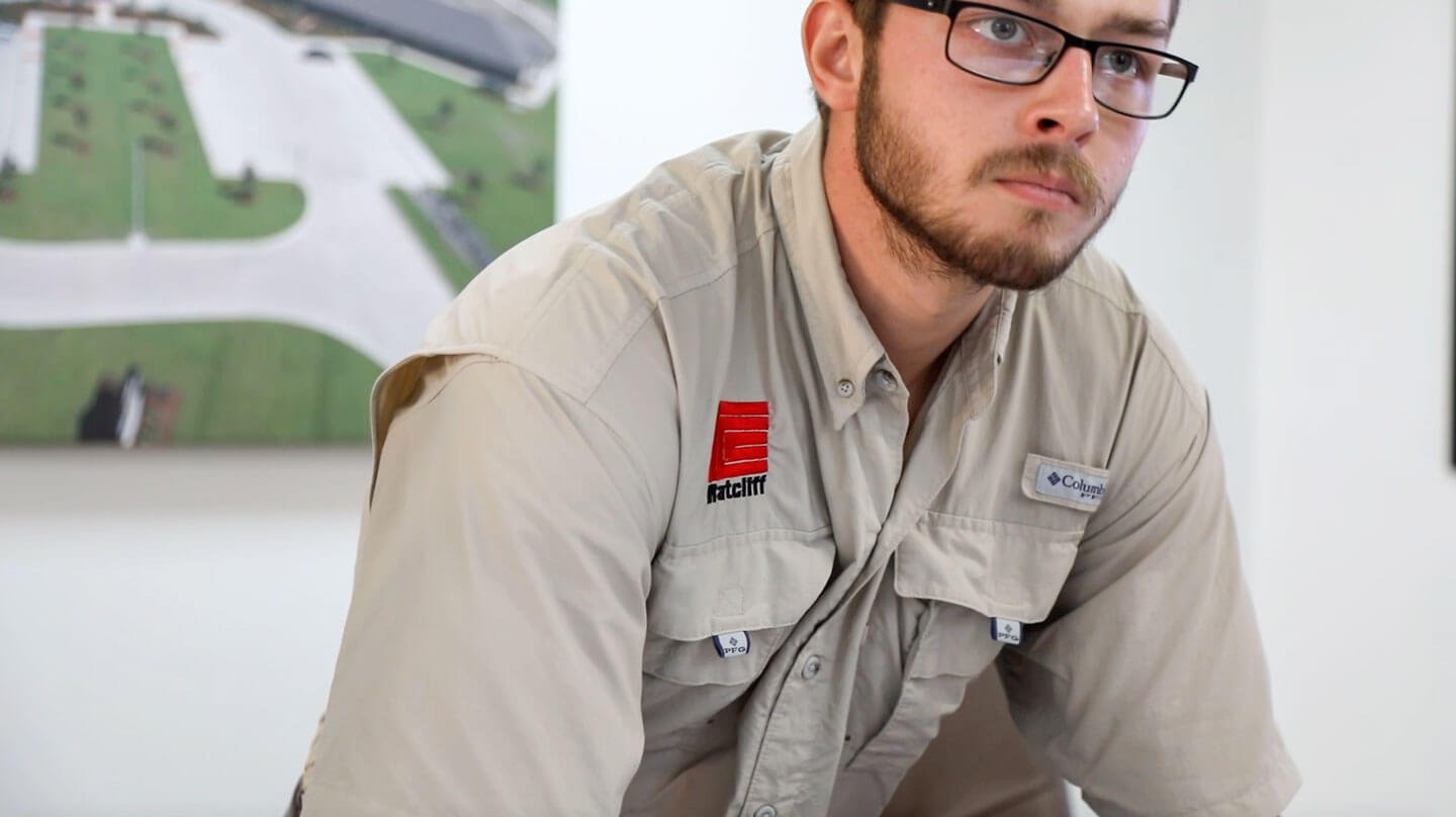 employee wearing branded shirt asking about commercial construction jobs