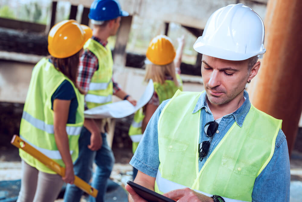 Workers assessing structure after disaster recovery services